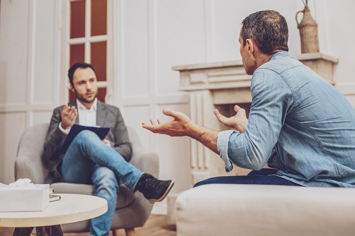 Competent Male Therapist Talking With His Patient